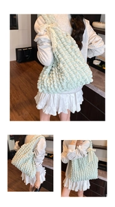 Detail of mint green quilted tote bag with cream lace bow and bubble texture fabric