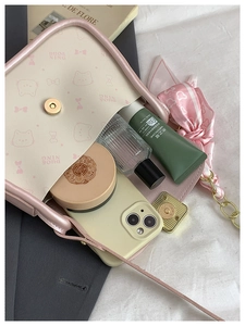 Interior view showing the storage capacity of the pink bow shoulder bag for daily essentials