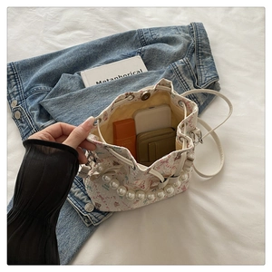 Floral bucket bag interior showing magnetic clasp and daily essentials storage capacity