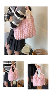 Detail view of pink popcorn texture tote bag with lace bow decoration and soft fabric