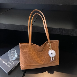 Brown leopard print tote bag with plush monster charm and sleek double shoulder straps