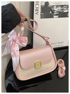 Close-up of pink luxury mini square bag with golden buckle and heart pattern scarf