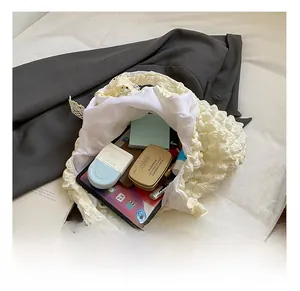 Macro view of beige bubble nylon tote bag capacity showing tablet and cosmetics