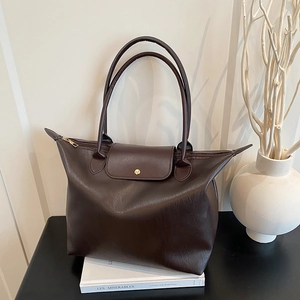 Brown faux leather tote bag with long handles and golden snap button closure
