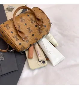 Interior view of brown Boston mini bag showing capacity for phone and cosmetics
