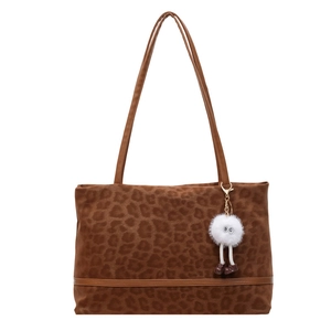 Vintage leopard print tote bag with plush charm and leather straps for women