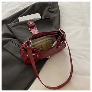 Detail view of the spacious inner compartment and matte burgundy leather of the bag