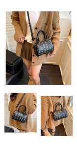 Detail of a black mini Boston bag with cartoon bear print and silver-tone metal hardware