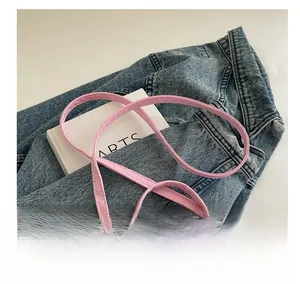 Detailed shot of pink lace crossbody bag featuring a 3D bow and delicate floral trim