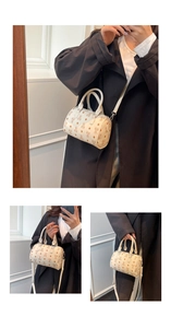 Detail of a vintage-style cream Boston bag featuring bear and diamond geometric prints