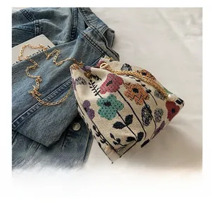 Detailed shot of vintage bucket bag with floral jacquard and gold chain strap