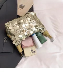 Detail view of gold sequin underarm bag showing spacious interior with beauty essentials