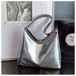 Metallic silver hobo shoulder bag with a modern trapezoid shape and leather strap