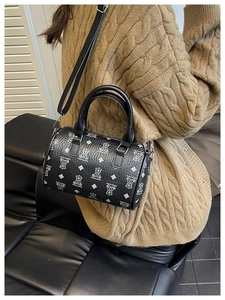 Detailed view of the black Boston bag with white bear print and silver hardware details
