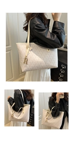 Detailed view of cream leather tote bag featuring monogram print and golden letter charm
