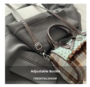 Detail of adjustable metal buckle on shoulder strap of starry pattern Boston bag