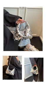 Detail of silver sequin handbag featuring a metallic handle and long tassel fringe decoration