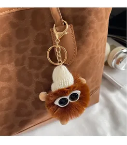 Creative brown plush doll charm with white knit hat and sunglasses on tote bag