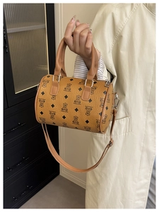 Detail of bear print boston bag with leather handles and silver zipper hardware