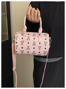 Detailed view of pink Boston bag with bear patterns and silver-tone metal hardware