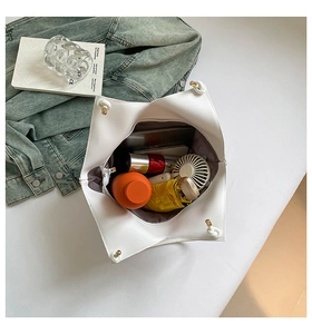 Top view of white large tote bag showing spacious interior with knots and metal accents
