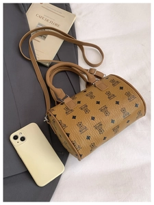 Macro detail of retro brown boston bag with bear print and leather texture