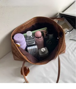Spacious interior of leopard print tote bag holding water bottle, umbrella and daily essentials
