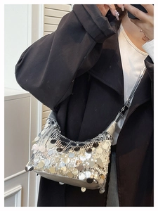 Macro view of sparkly silver sequins texture on a designer crescent underarm bag