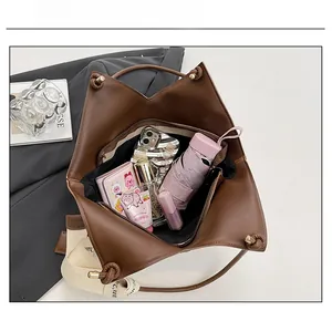 Top view of large straw tote bag showing spacious interior with umbrella and wallet