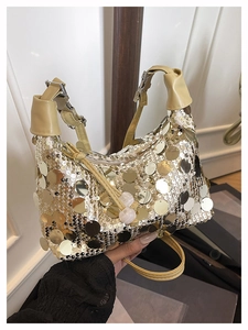 Detail of sequin underarm bag with zipper closure and adjustable beige leather strap