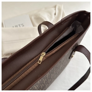 Close-up of the vintage monogram tote bag interior with gold zipper and gray lining