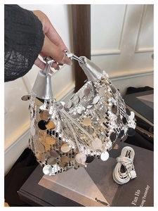 Close-up of shiny silver sequins and metal handle on this trendy baguette handbag