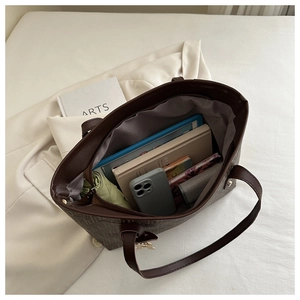 Interior view showing the large capacity and daily essentials of the brown tote bag