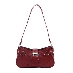 Minimalist deep red Y2K baguette bag with silver buckles and studs on white background