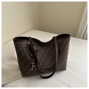 Detail of high-capacity tote bag with brown DL monogram print and silver R pendant