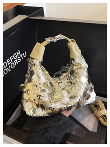 Detailed close-up of glittering sequins and a silver metal clasp on a stylish handbag