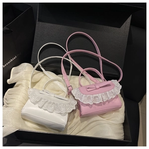 Detail of pink and white mini bags with lace trim and bow knot in a luxury gift box
