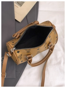 Detail view of the spacious black interior and zipper of the vintage printed barrel bag
