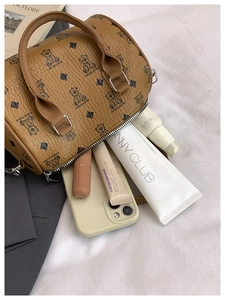 Internal view of mini Boston bag showing capacity for phone and cosmetics