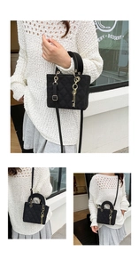 Close-up of black quilted nylon bag featuring rhombus stitching and gold key charm accessory