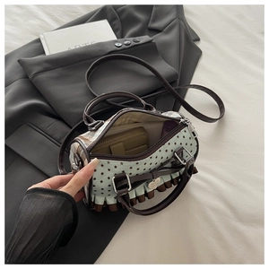 Detail of mint green Boston bag with star print and ruffle trim showing internal capacity