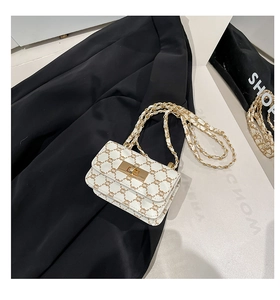 Detail view of retro mini flap bag with vintage monogram and gold metal chain strap