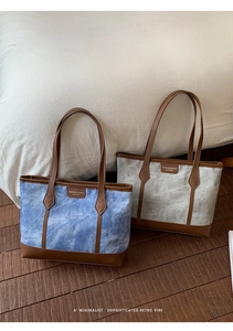 Detail of washed canvas tote bags with premium leather trim and comfortable handles