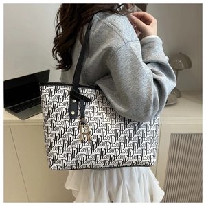 Detail of off-white tote bag featuring full letter print and gold R-pendant