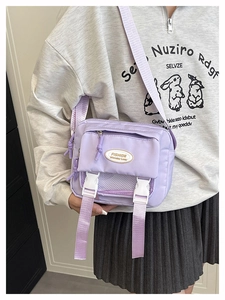 Detail of light purple nylon messenger bag with buckle closures and adjustable shoulder strap