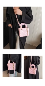 Detail of pink quilted patent leather bag with gold letter charms and metal handles