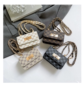 Flat lay of vintage plaid chain crossbody bags in cream, brown, grey, and black