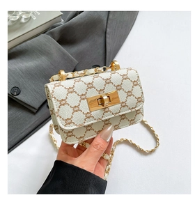 Detail of white monogram chain bag with gold twist lock and grainy leather texture