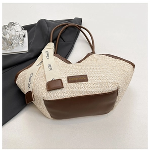 Close-up of woven straw tote bag with brown faux leather trim and fashion ribbon detail