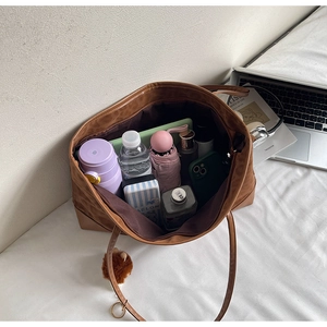 Detailed interior of a brown tote bag showing large capacity for daily essentials